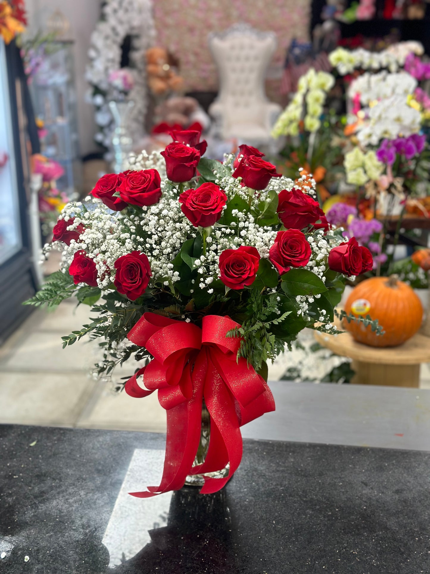 24 red roses in a vase